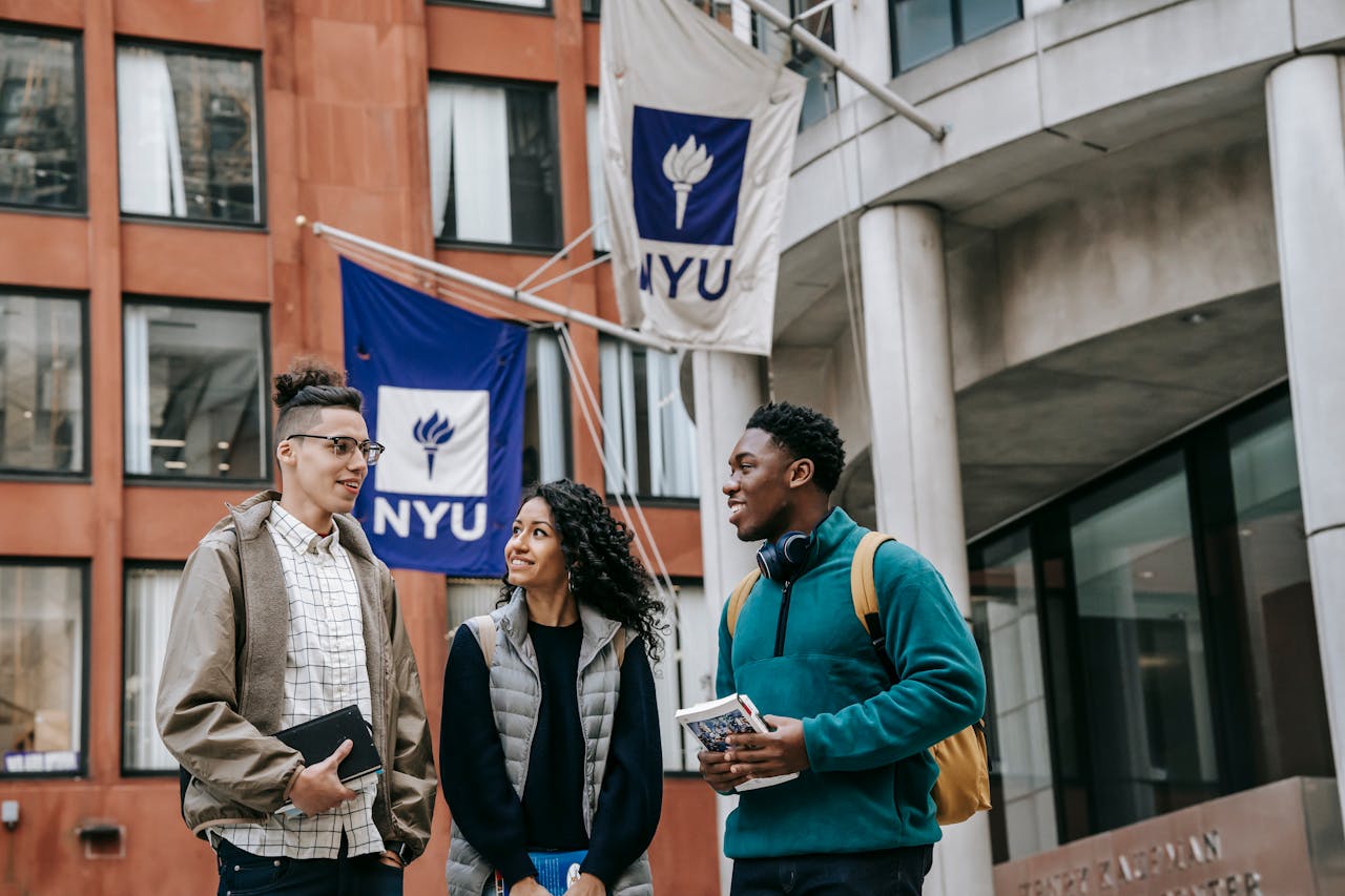 Diverse group of college students talking outside NYU, reflecting university life and diversity.