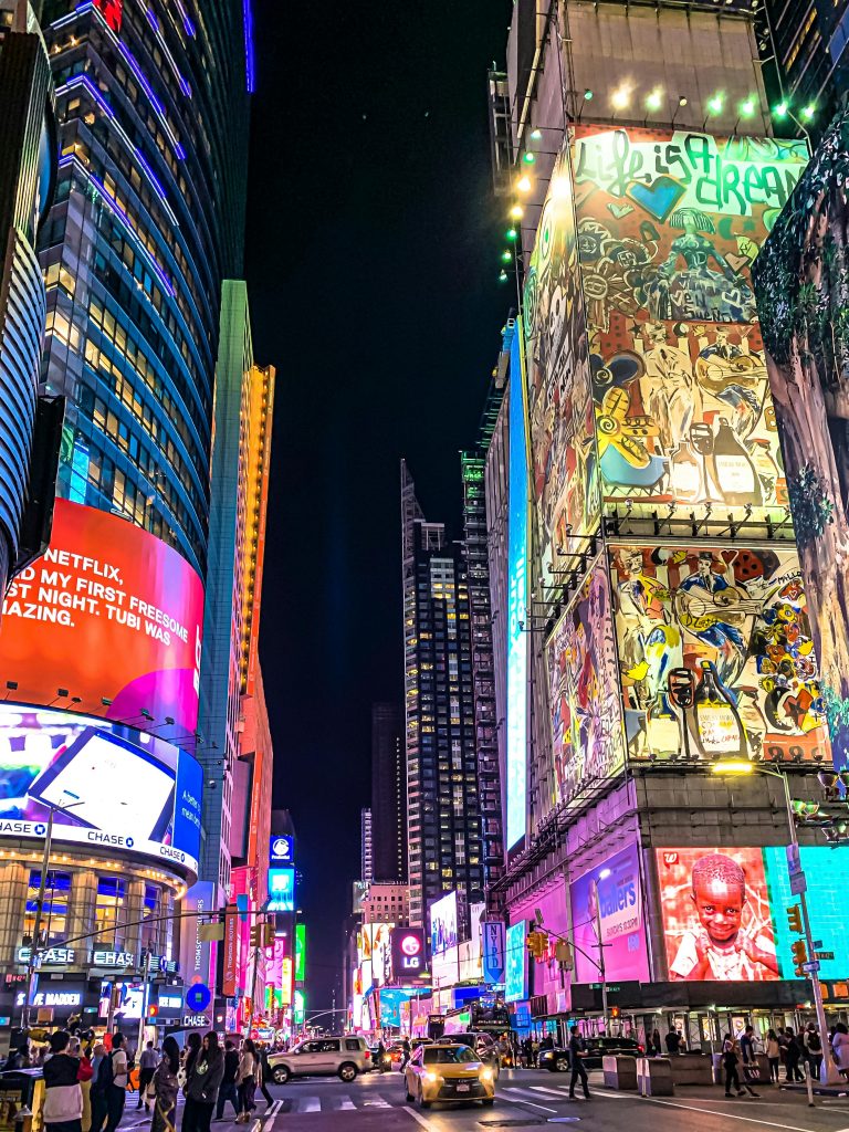 Immersive view of Times Square's nightlife with vibrant billboards and bustling traffic.